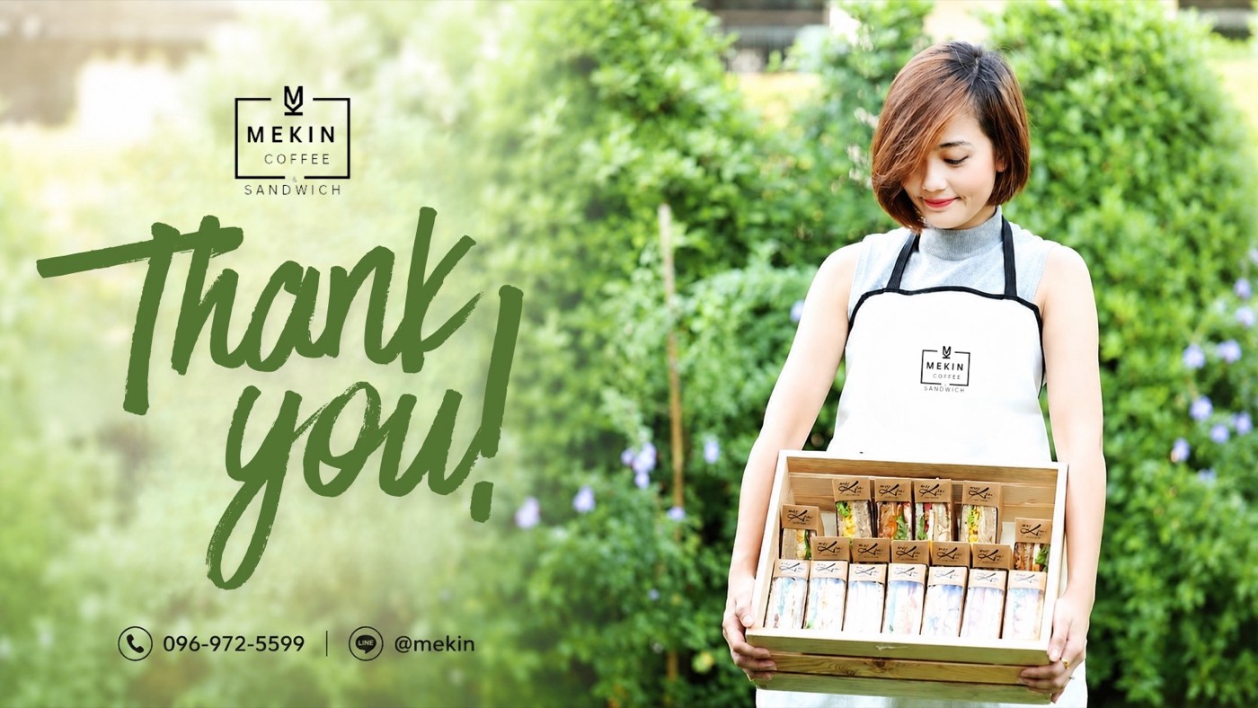 Mekin team member presenting a box of fresh sandwiches